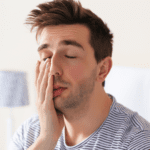 Man Rubbing Eyes. Alcohol and Eyesight