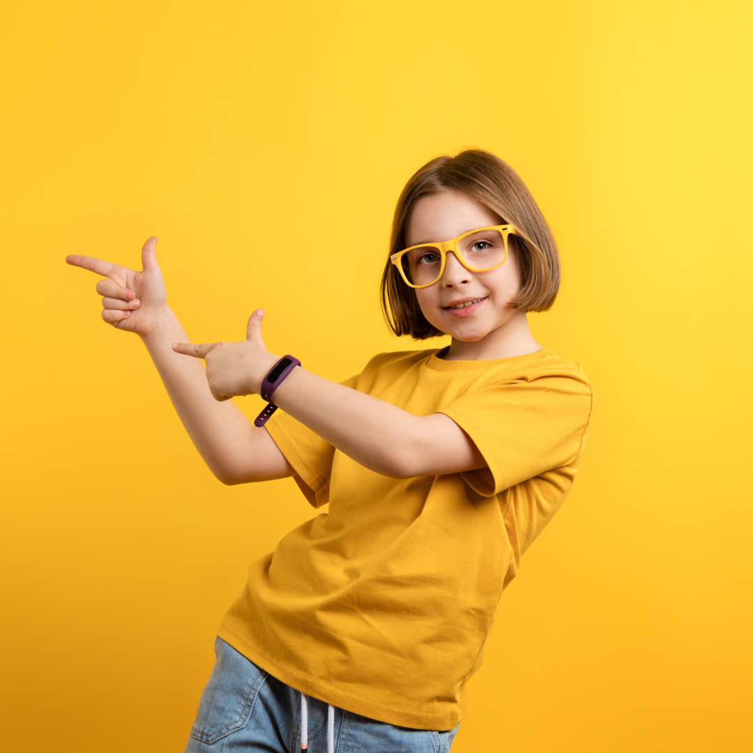 Confident girl wearing yellow t shirt and matching glasses
